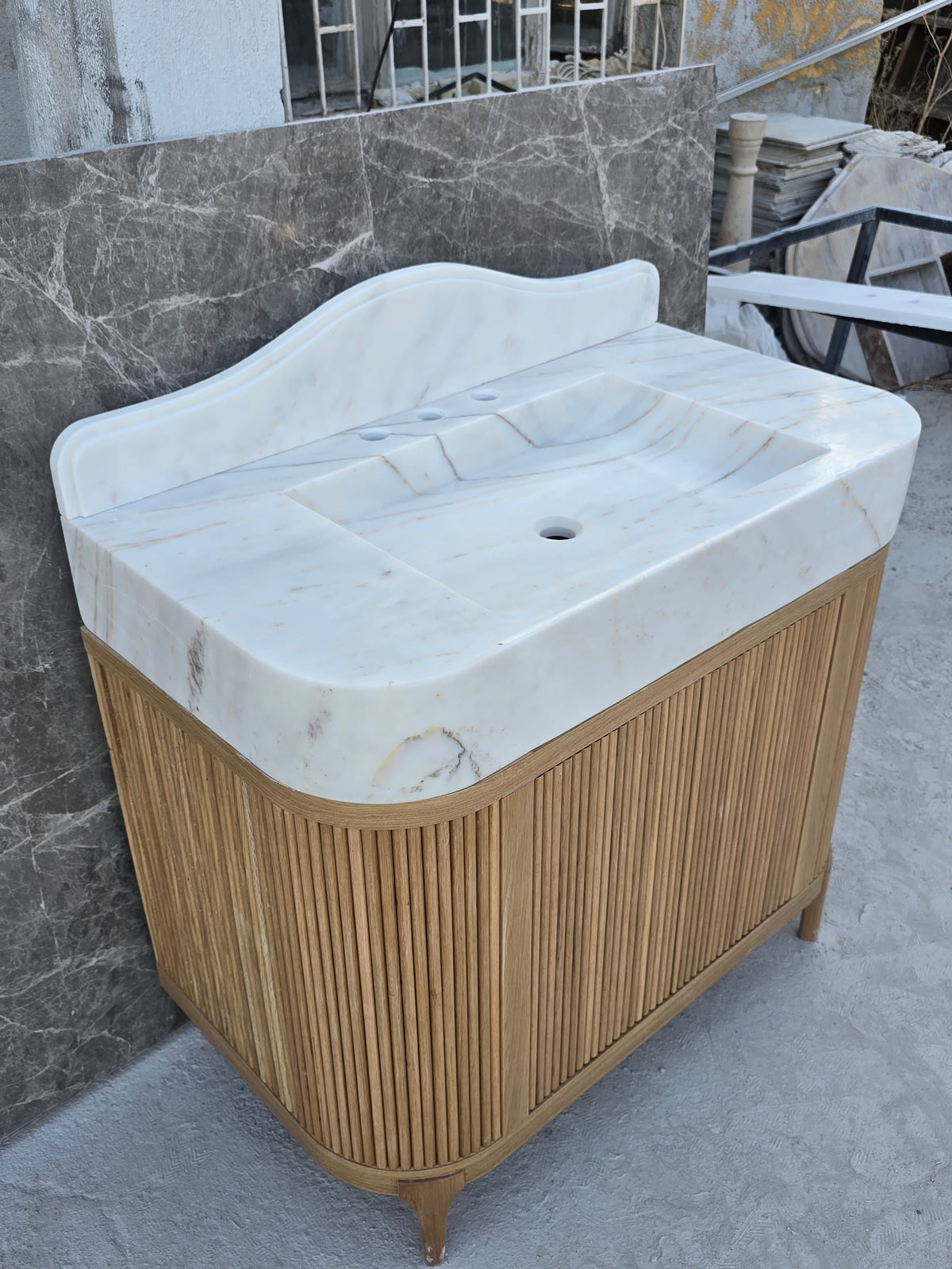 Custom single blok marble sink with wood cabinet
