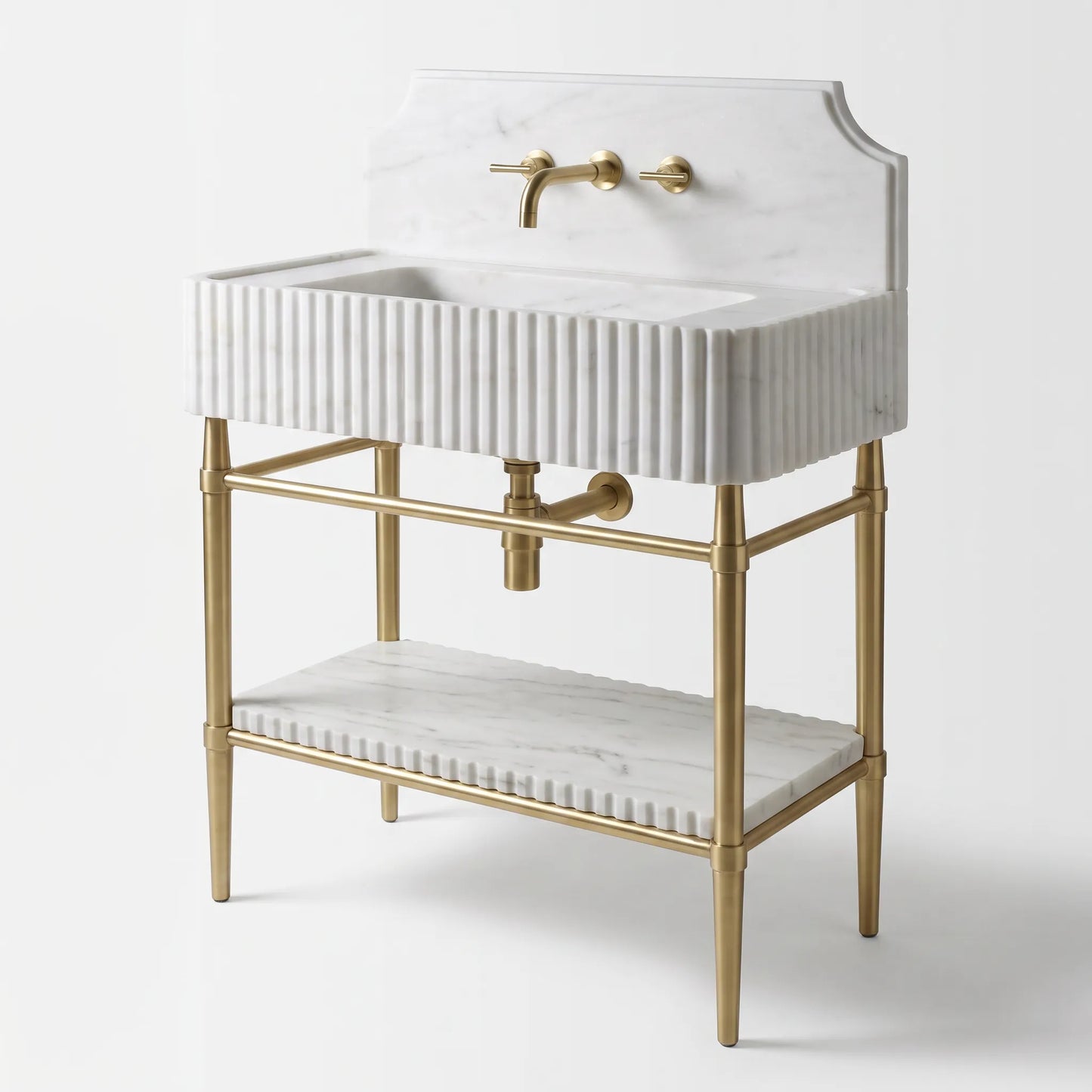 A freestanding bathroom vanity with a white marble sink and matching marble shelf, supported by a gold metal frame with a curved backplate and gold faucet hardware.