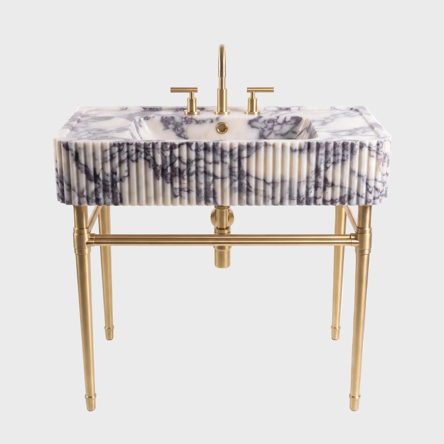 A modern bathroom vanity featuring a rectangular white marble sink with dark gray veining, supported by a gold-finished metal frame with fluted detailing and a matching gold faucet.