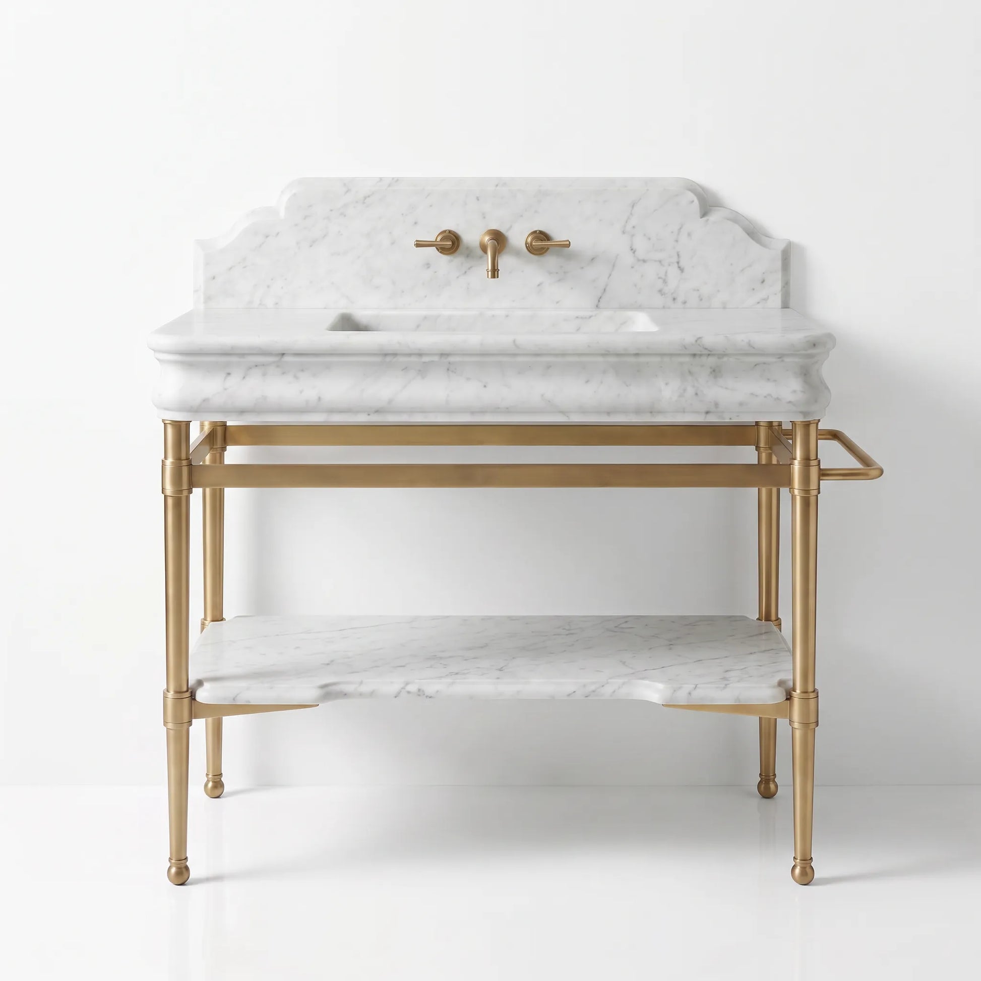 A freestanding bathroom vanity with a white marble sink top and shelf, supported by a gold brass frame with a matching faucet and warm brass handles.