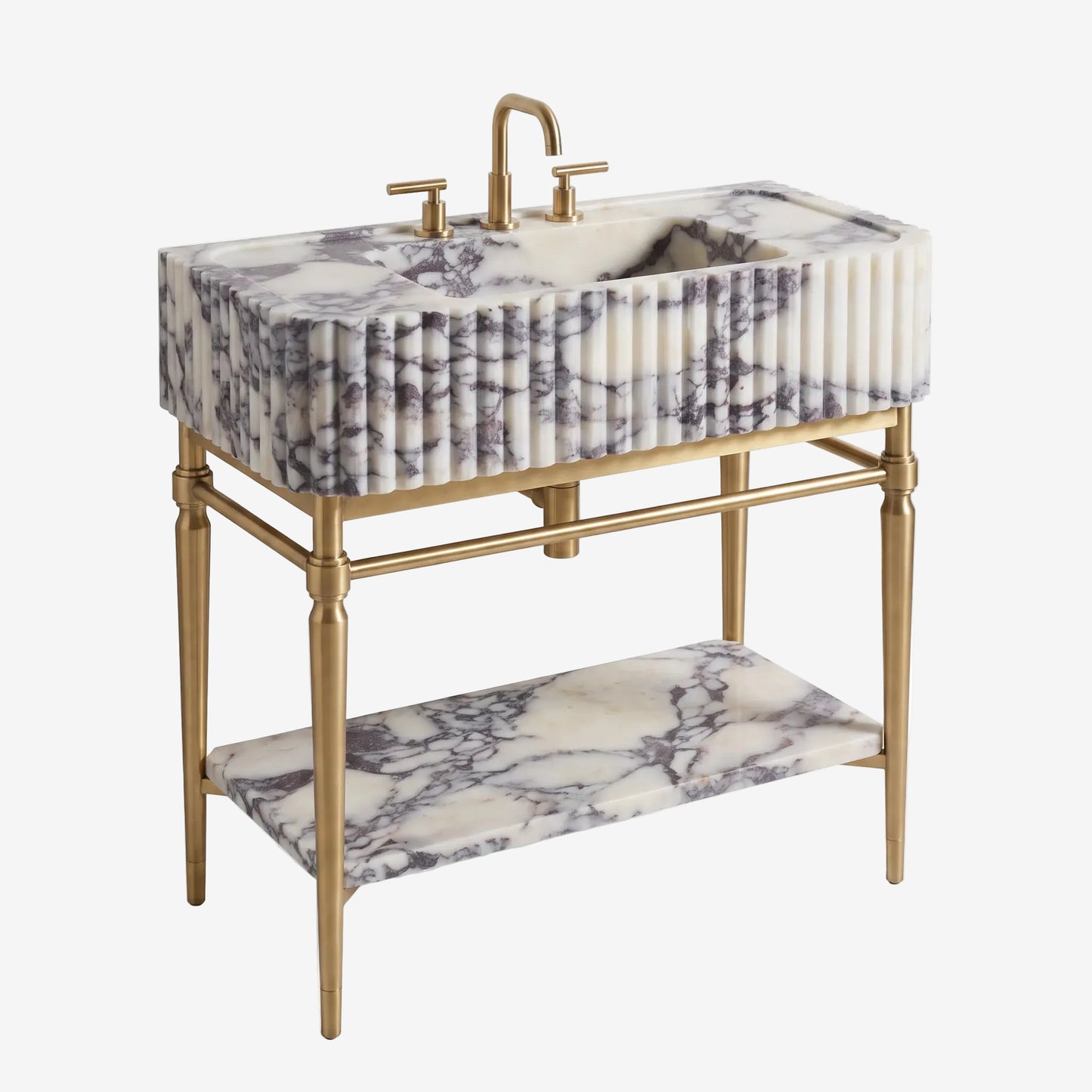 A vintage-style washstand with a rectangular double basin carved in white marble with gray and black veining, supported by a gold-finished metal frame with a lower shelf.