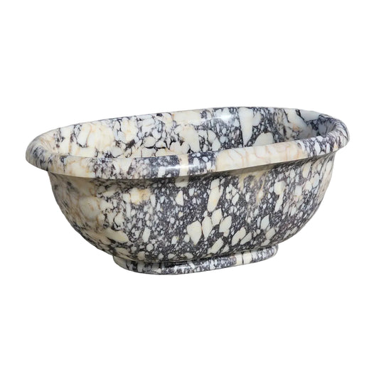 Marble Bathtub with black and white patterns on a stone surface