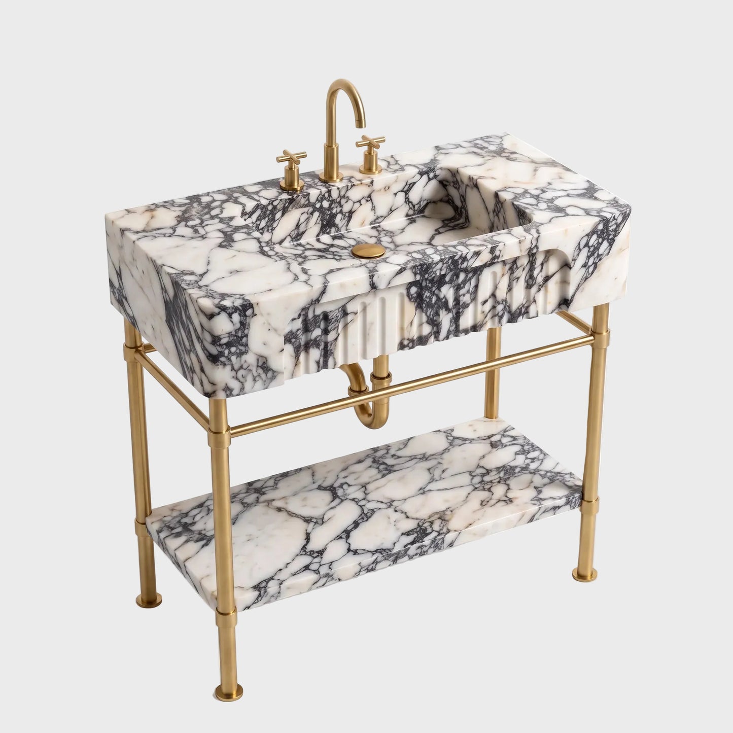 A freestanding bathroom vanity with a rectangular white marble sink top featuring dramatic black veining, a matching marble shelf, and a polished gold brass faucet, pipe, and stand.