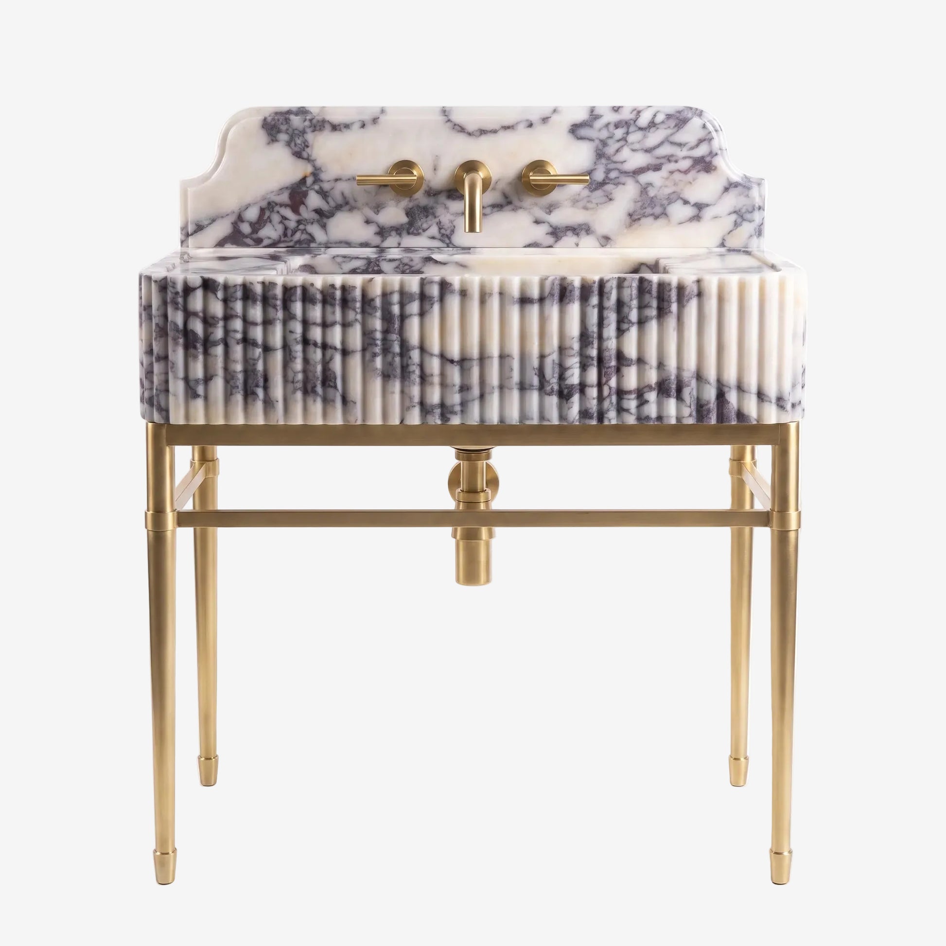 A modern bathroom vanity featuring a pleated marble sink top and matching backrest with a black and white marble pattern, supported by a polished gold brass frame with a central pedestal drain and dual lever faucets.