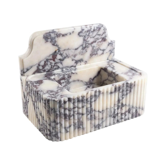 A rectangular marble tissue box cover with a fluted front edge and an open top lid, featuring a white, cream, and gray veined pattern, photographed on a clean white background.