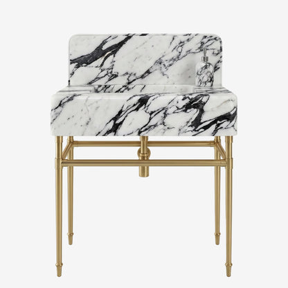 A modern vanity sink with a white marble basin featuring dramatic black veining, supported by a sleek gold-finished metal frame with a matching gold faucet.