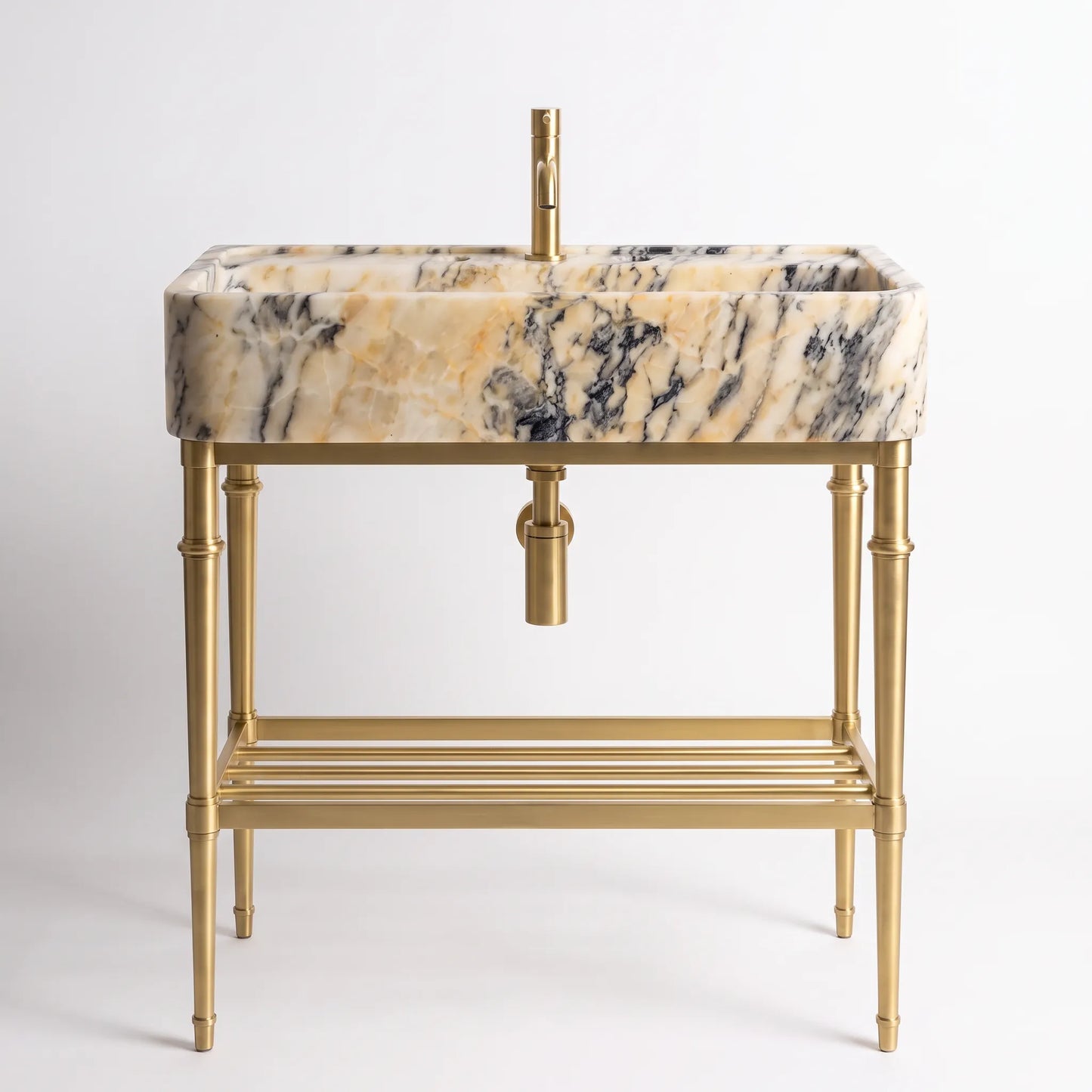A modern bathroom vanity set featuring a rectangular basin with a beige, cream, and black marble pattern, supported by a polished gold brass stand with a bamboo-inspired leg design and a lower shelf.