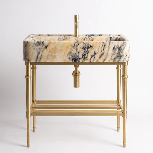 A modern bathroom vanity set featuring a rectangular basin with a beige, cream, and black marble pattern, supported by a polished gold brass stand with a bamboo-inspired leg design and a lower shelf.