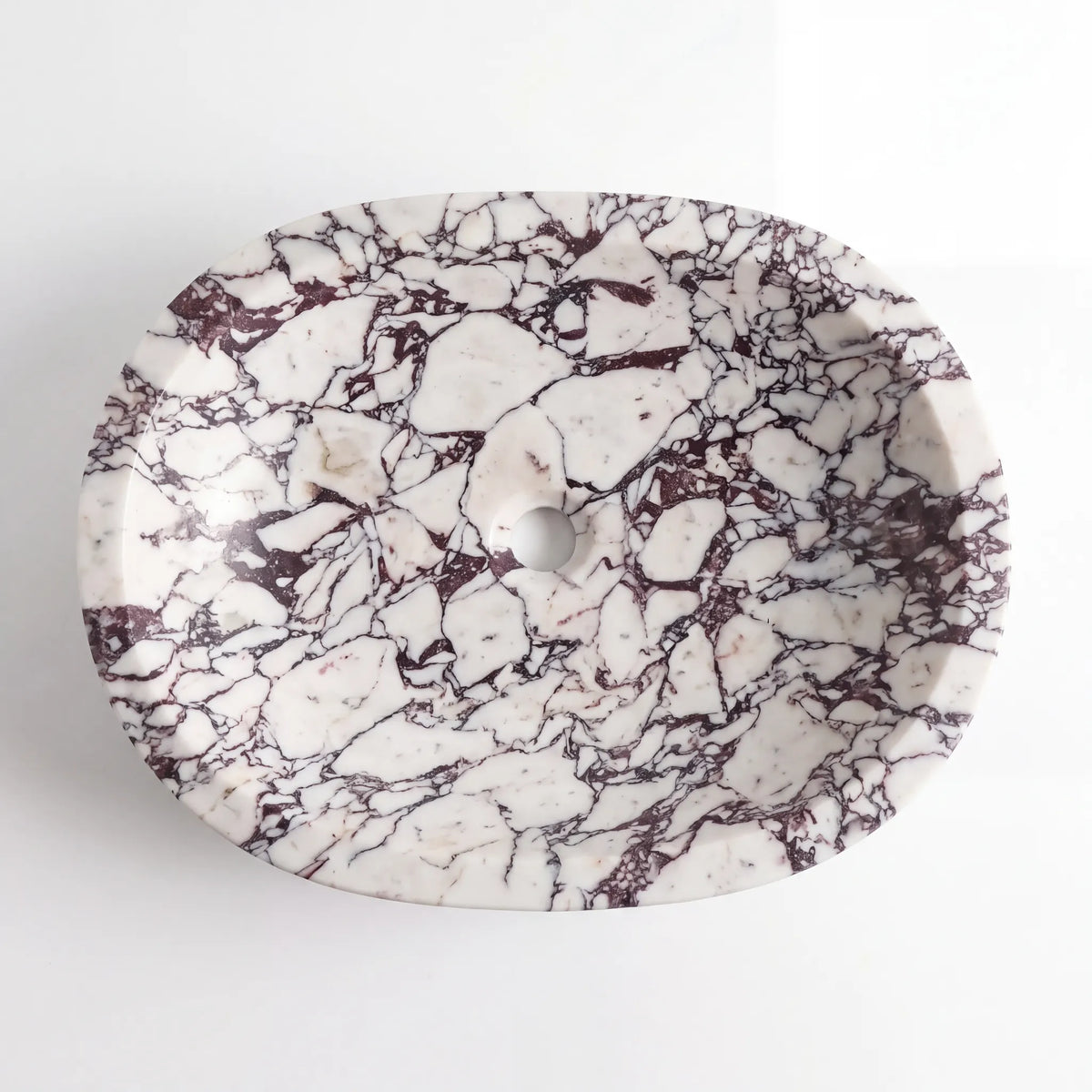 Detailed view of RMD-028 Violavena Calacatta Viola marble vessel sink showing dramatic natural veining