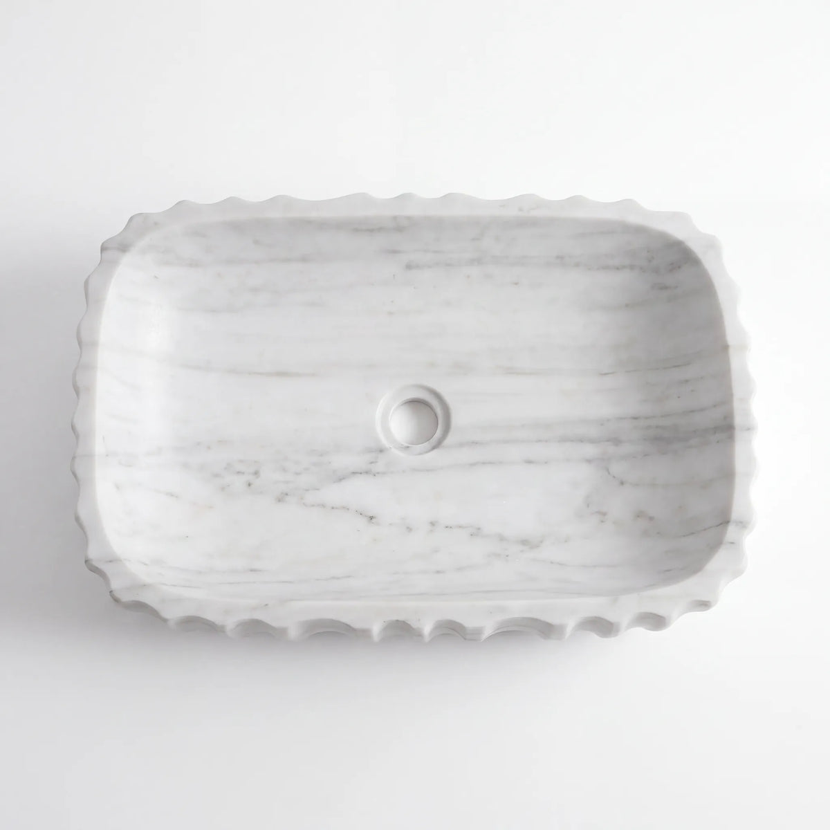 Detailed view of RMD-060 Carravelle Carrara white marble vessel sink showing soft natural veining