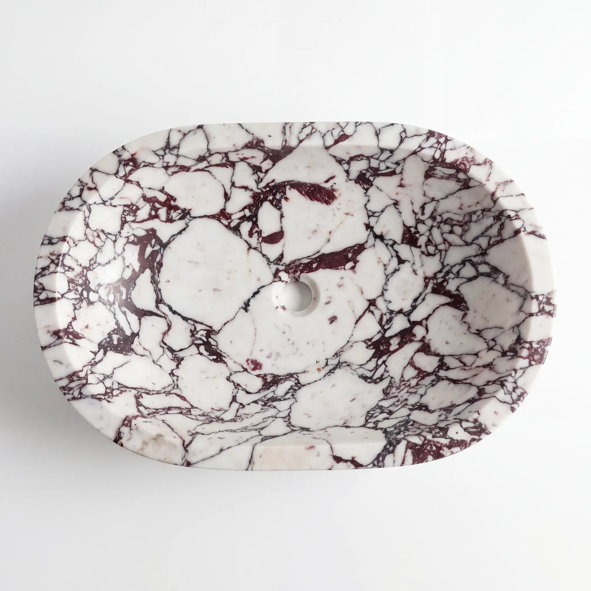 Detailed view of RMD-100 Violara Calacatta Viola marble vessel sink showing dramatic natural veining