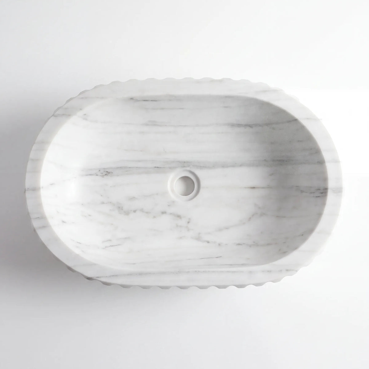 Detailed view of RMD-106 Carralora Carrara white marble vessel sink showing soft natural veining