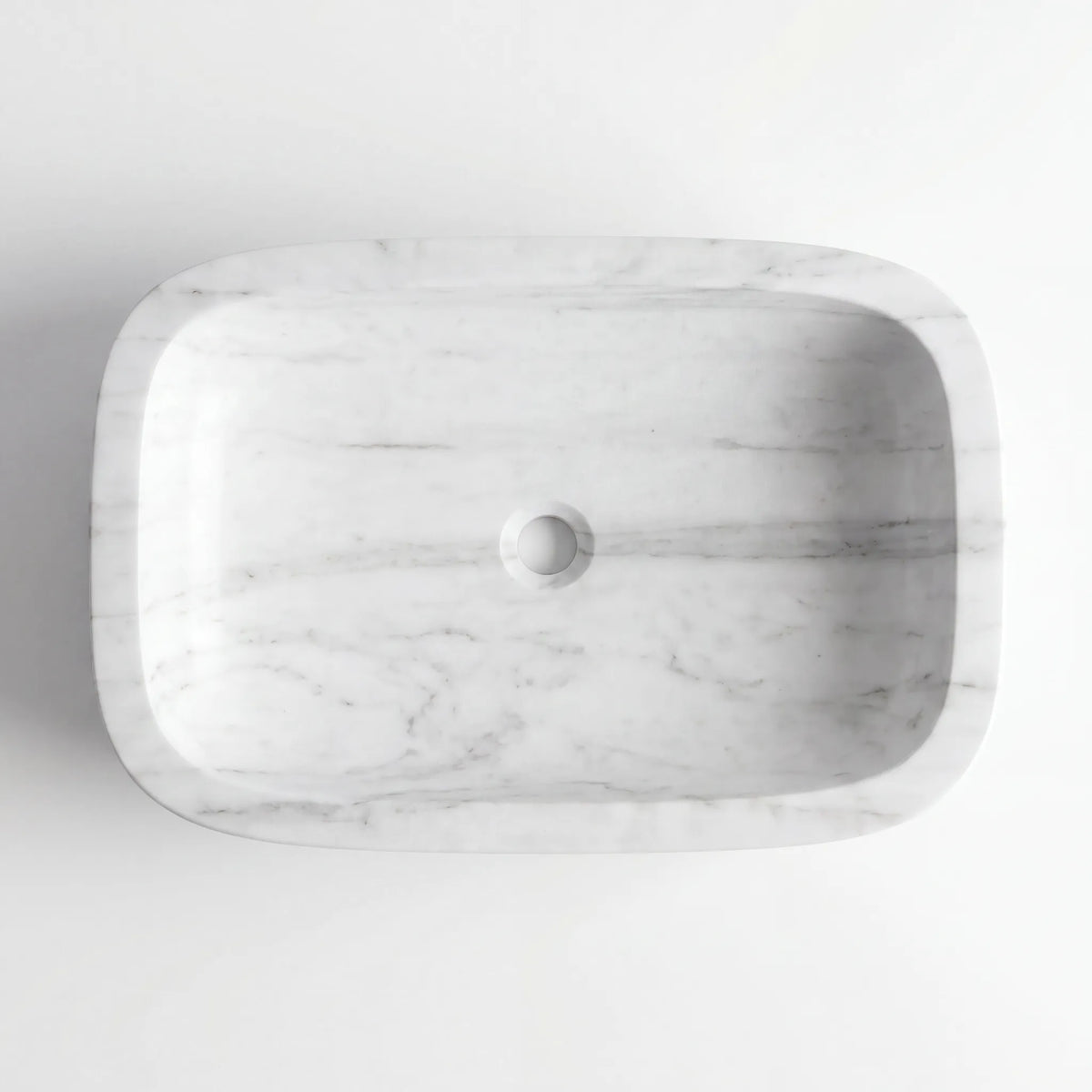 Detailed view of RMD-127 Carralisse Carrara white marble vessel sink showing soft natural veining