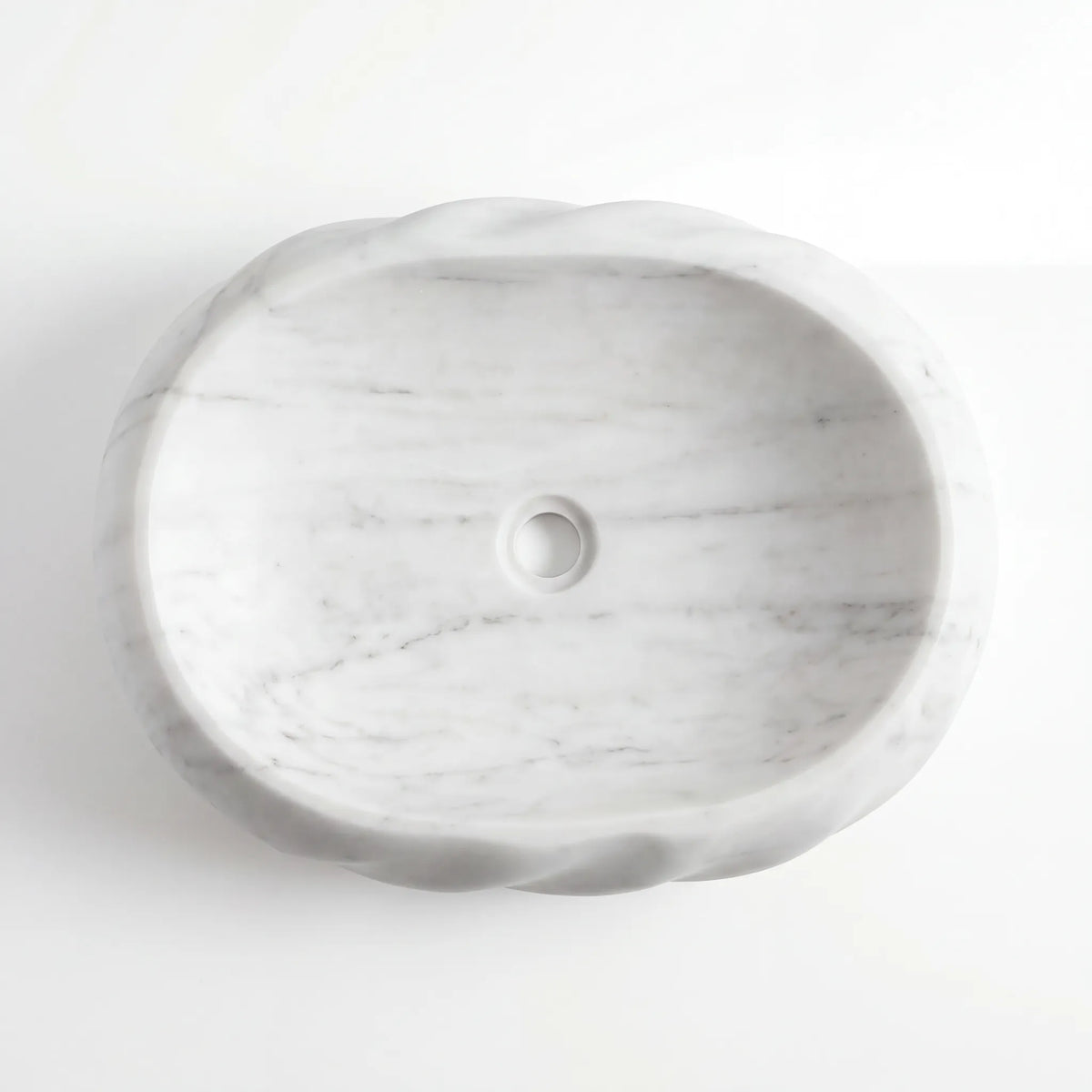 Detailed view of RMD-147 Carrenza Carrara white marble vessel sink showing soft natural veining