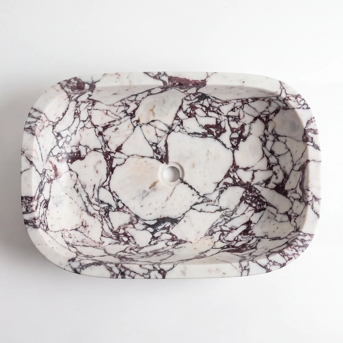 Detailed view of RMD-171 Violenza Calacatta Viola marble vessel sink showing dramatic natural veining