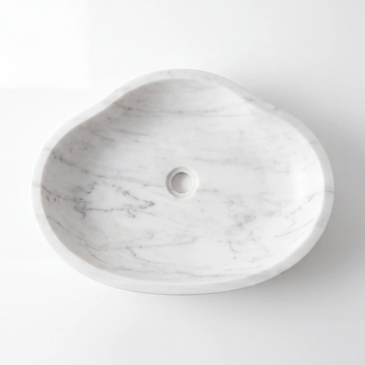 Detailed view of RMD-182 Carranova Carrara white marble vessel sink showing soft natural veining