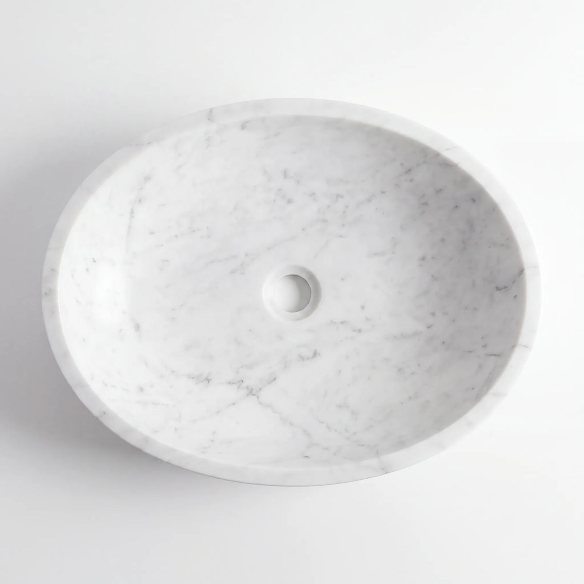 Detailed view of RMD-194 Carralune Carrara white marble vessel sink showing soft natural veining