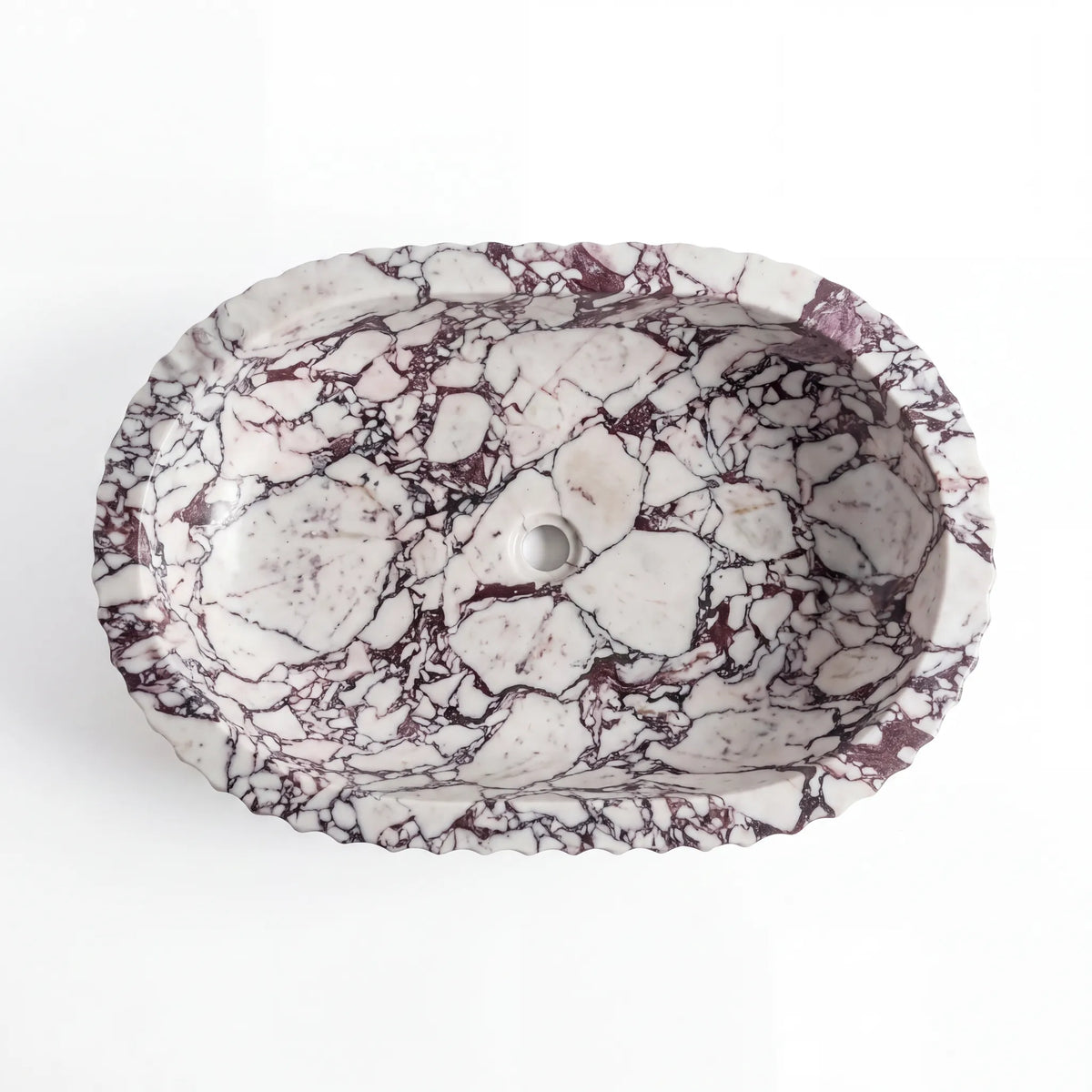 Detailed view of RMD-212 Violenza Calacatta Viola marble vessel sink showing dramatic natural veining