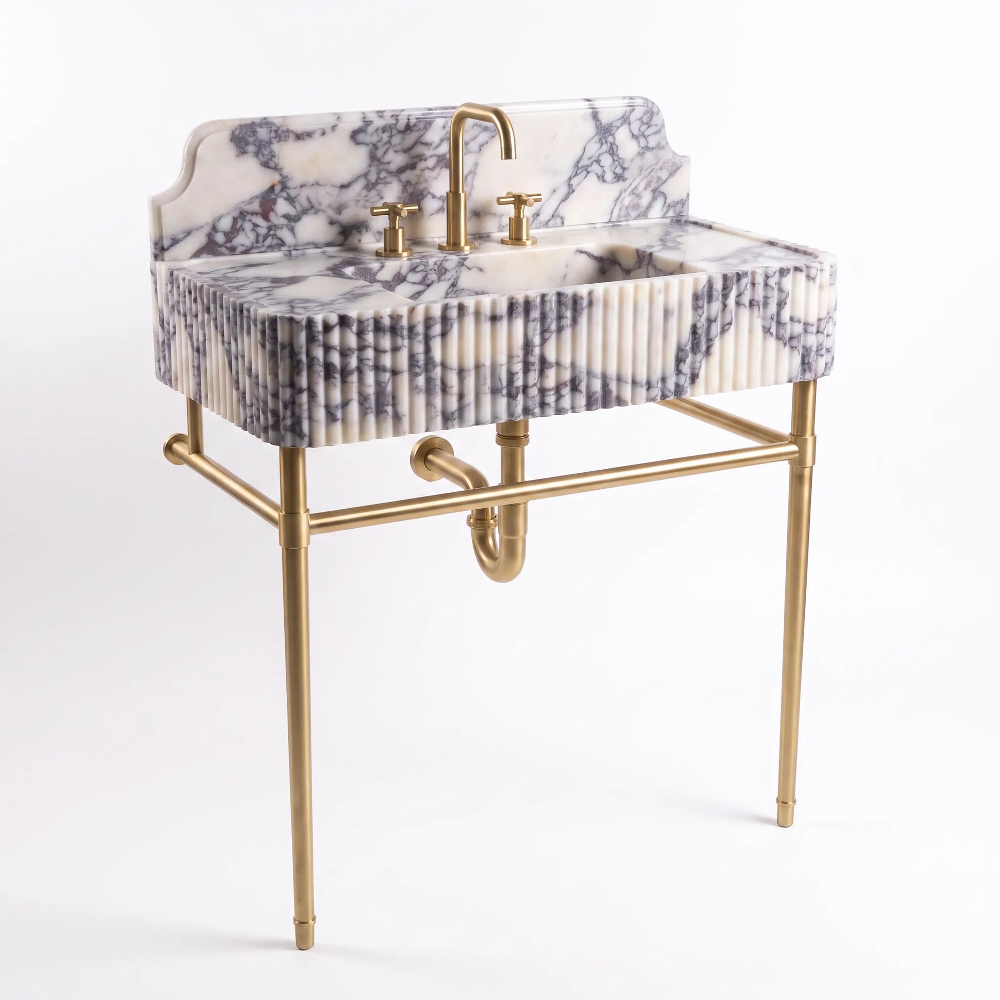 A modern bathroom vanity sink with a white and gray marble-patterned basin and backplate, supported by a gold-finished metal stand with a curved faucet and two-handle fixture.