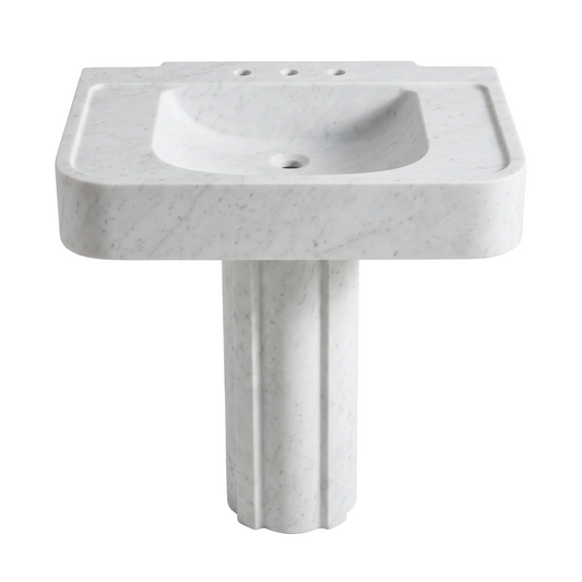Avelino custom Carrara White marble pedestal bathroom sink with thick rounded basin, sculpted fluted pedestal, integrated side deck grooves and three faucet holes