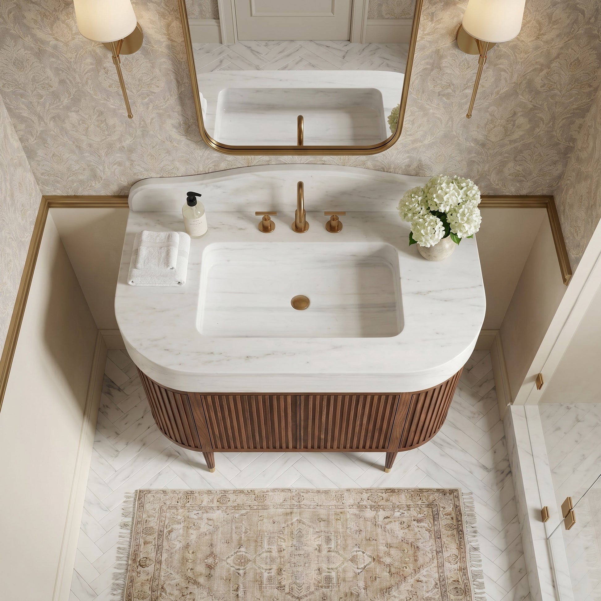 Custom Carrara marble bathroom vanity with integrated sink, sculptural curved backsplash and fluted walnut cabinet