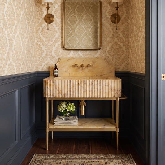 Essence 30 inch Calacatta Gold marble bathroom vanity with sink and solid brass console legs in a luxury bathroom